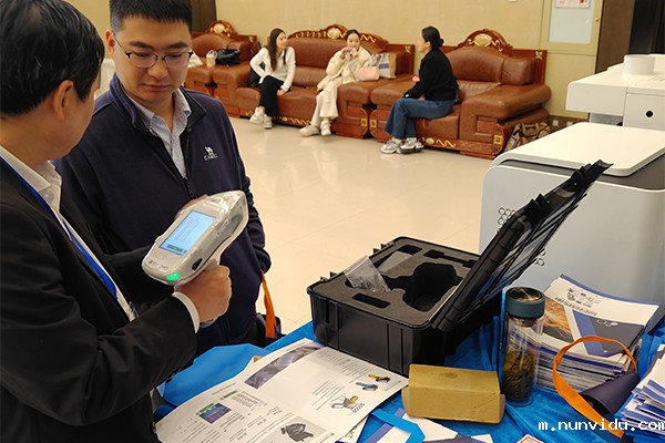 为嘉宾演示手持式光谱仪的操作